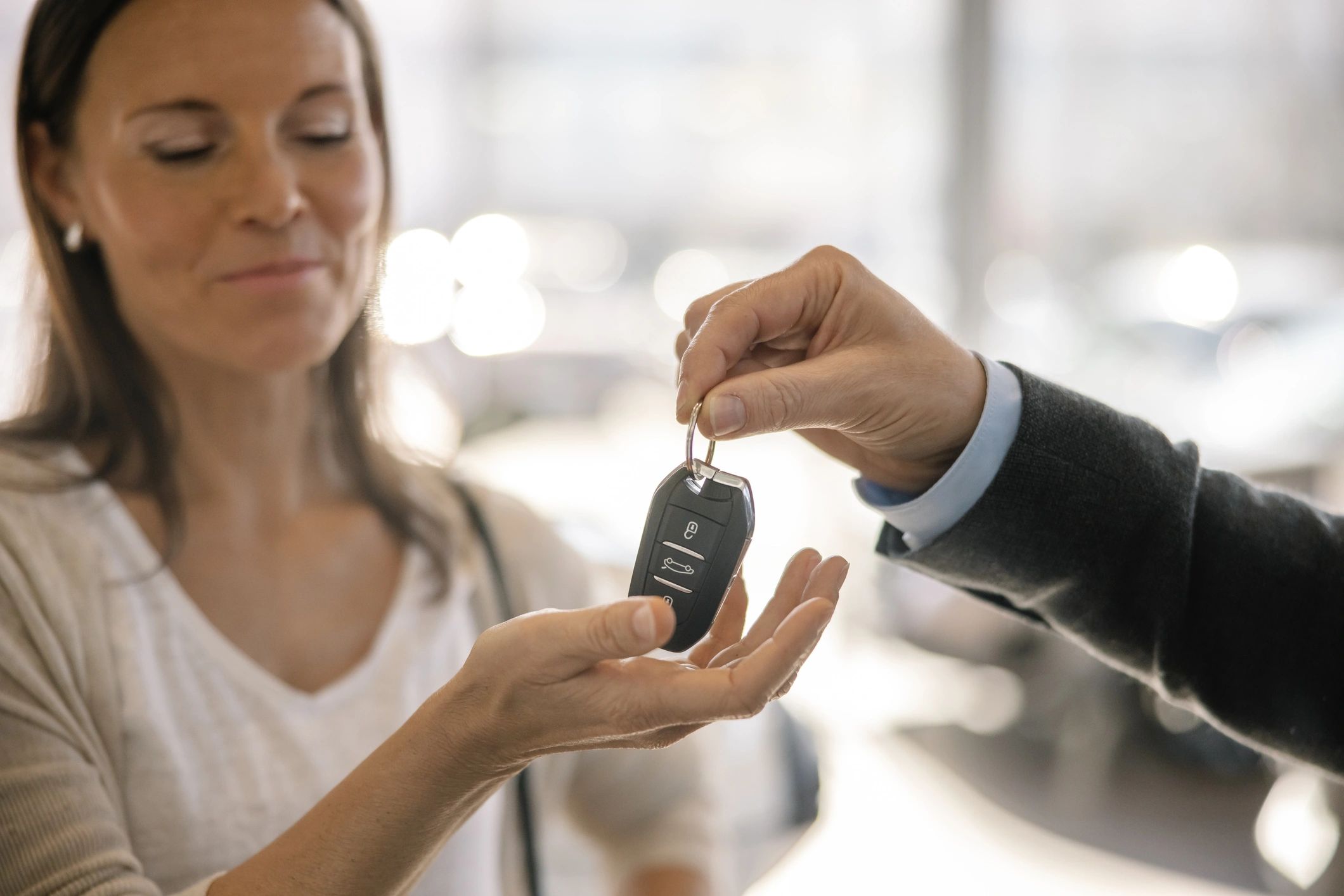 Customer receiving car keys from a rental representative